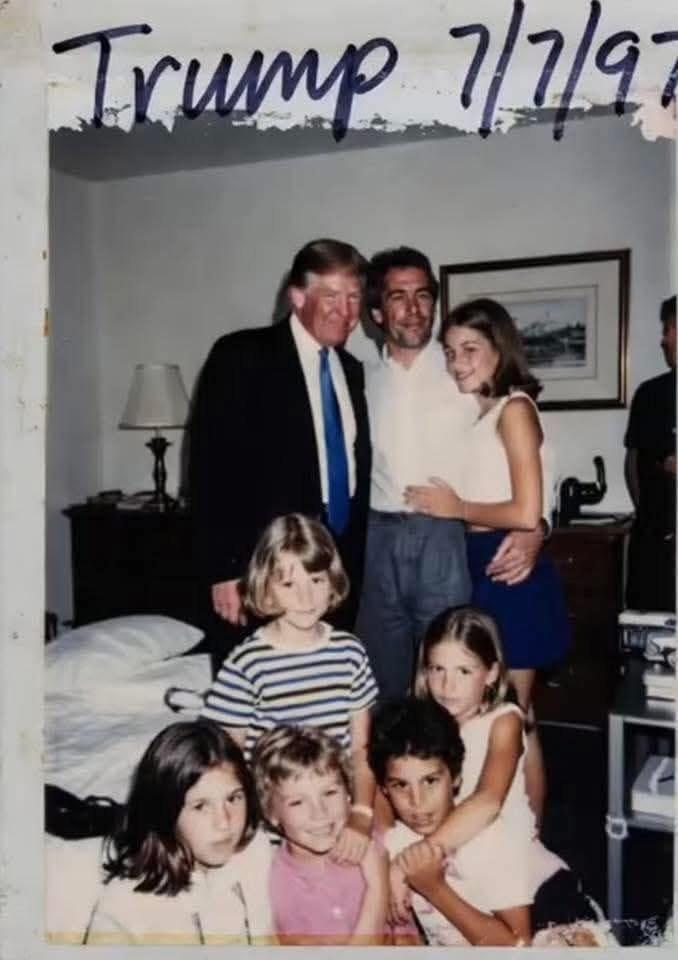 Snapshot-style photograph labeled “Trump 7/7/97” at the top, showing Donald Trump standing indoors with Jeffrey Epstein and a woman, while several children pose in front of them in what appears to be a bedroom setting.